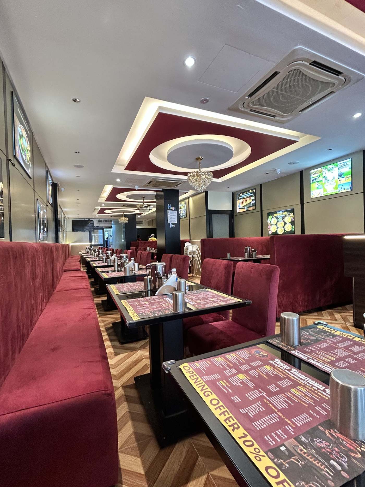 Maroon velvet booths inside Trichy Traditional Dining